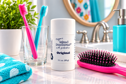 Natural deodorant for kids with colorful toothbrushes and hairbrush for an everyday hygiene routine