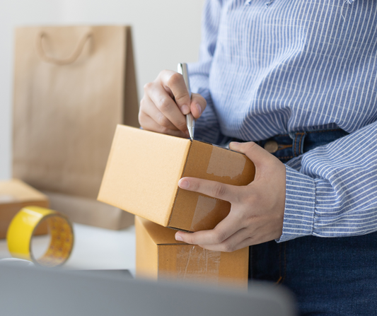 Small business owner preparing product shipment, representing the decision between private label and wholesale natural deodorant
