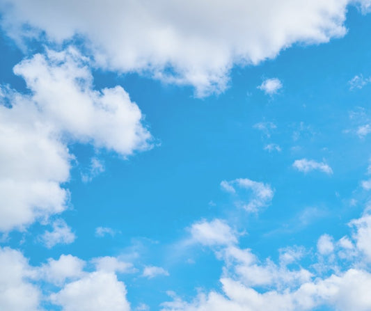 blue sky with white clouds representing clean, unscented deodorant