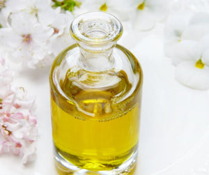 glass bottle with golden oil, gleam oil for hair