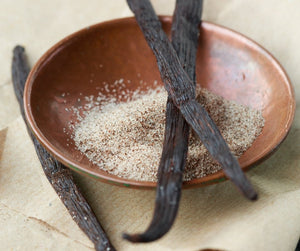 small wooden bowl, with 3 vanilla bean pods