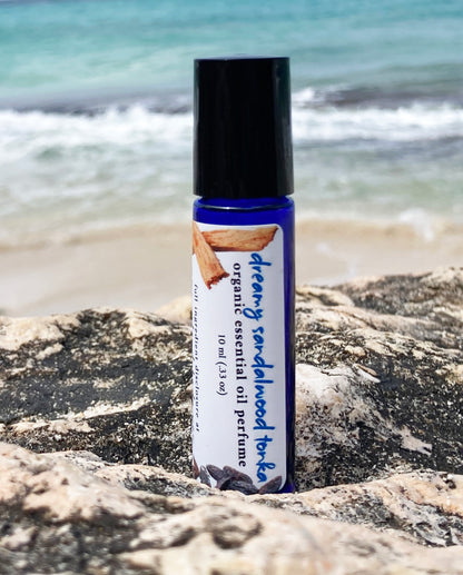 Natural sandalwood tonka essential oil perfume roll-on in blue glass bottle – organic non-toxic perfume oil by Island Deodorant.