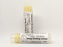 Two Island Deodorant organic cocoa butter lip balm tubes on a white background, one upright and one horizontal