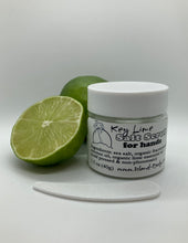 a cut lime, and a whole lime, and a 1.5 oz clear plastic jar of sea salt scrub with a tiny plastic spoon