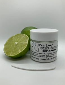 a cut lime, and a whole lime, and a 1.5 oz clear plastic jar of sea salt scrub with a tiny plastic spoon