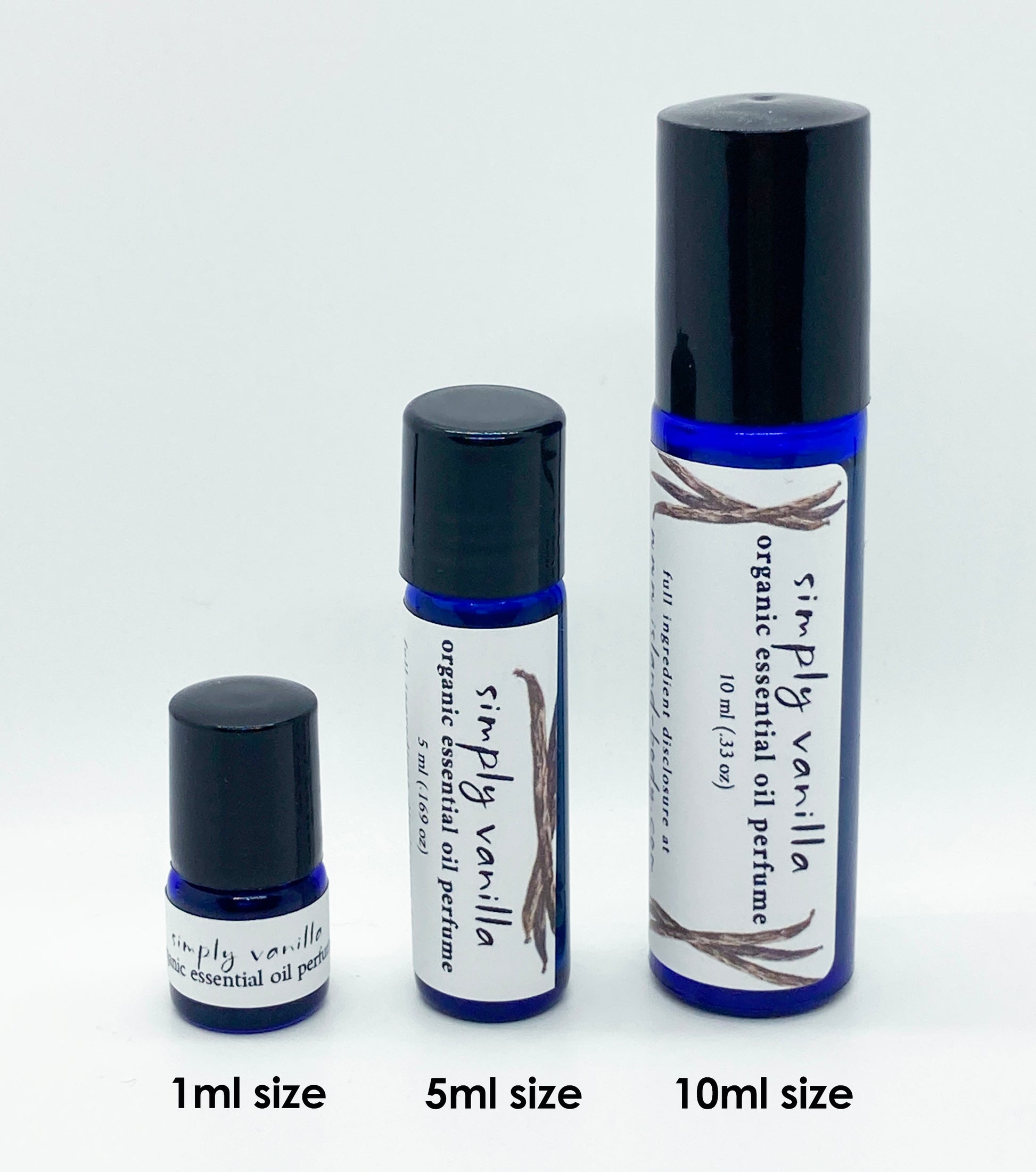 Three sizes of Simply Vanilla essential oil perfume roll-ons — 1ml, 5ml, and 10ml blue glass bottles labeled organic vanilla perfume, shown against a white background.