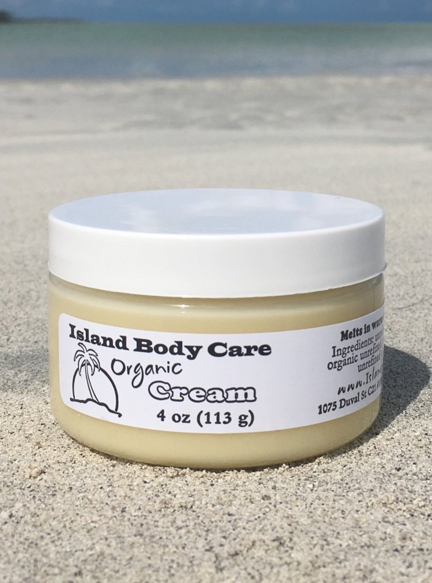 organic body cream with shea butter and jojoba oil in glass jar, unscented natural body moisturizer on beach