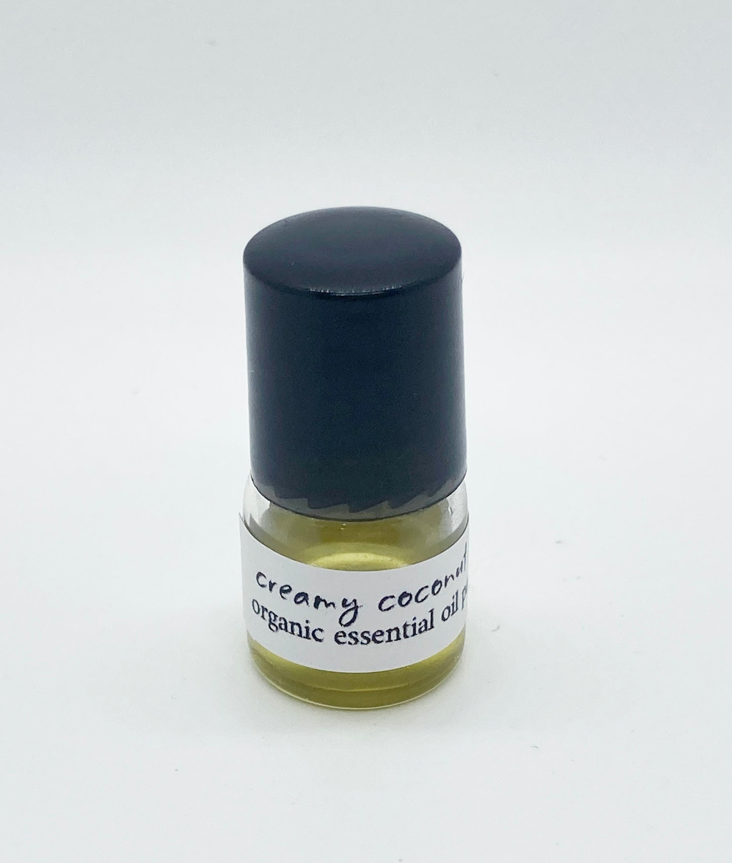 1ml sample bottle of Creamy Coconut Lime organic essential oil perfume with a black cap, shown against a white background.