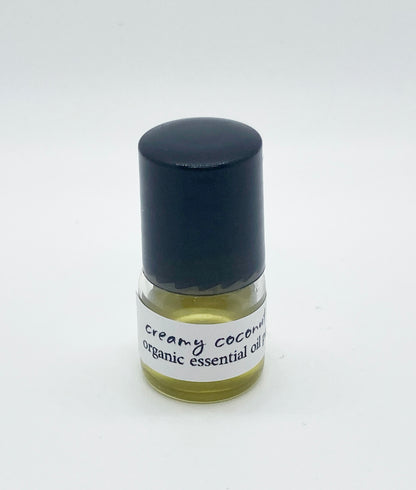 1ml sample bottle of Creamy Coconut Lime organic essential oil perfume with a black cap, shown against a white background.
