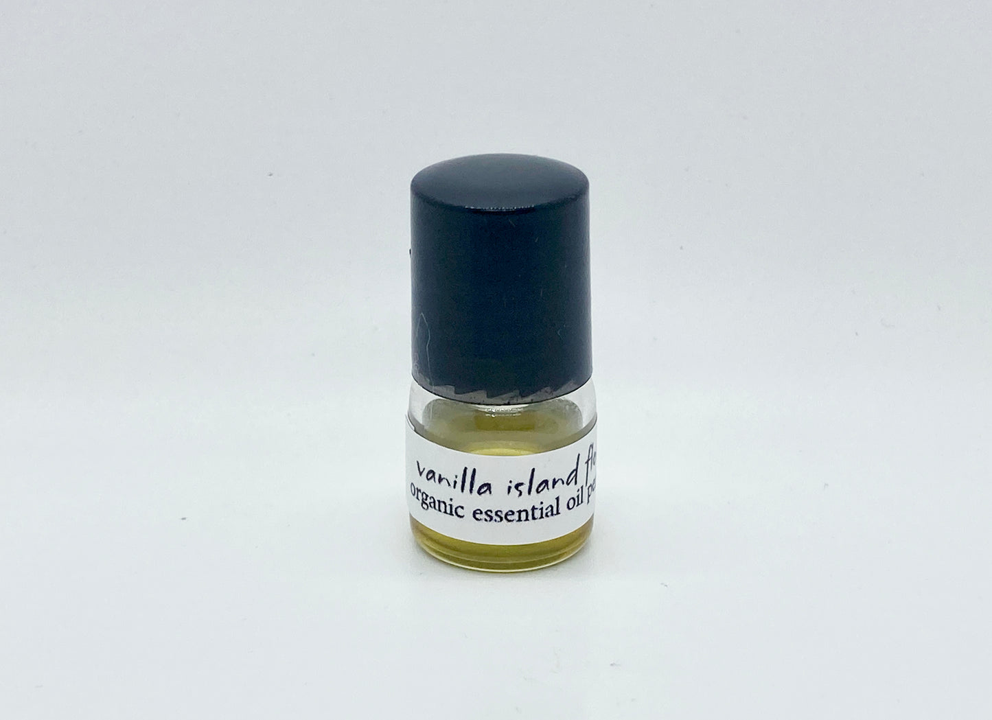 1ml sample bottle of Vanilla Island Flower essential oil perfume with black cap and white label — natural tropical vanilla perfume by Island Deodorant.