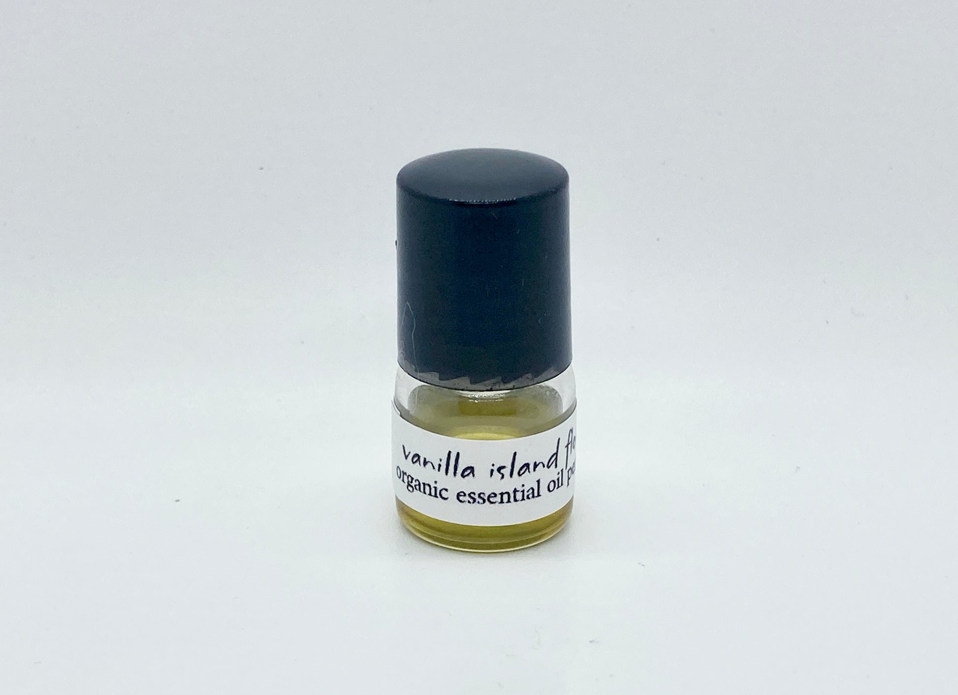 1ml sample bottle of Vanilla Island Flower essential oil perfume with black cap and white label — natural tropical vanilla perfume by Island Deodorant.