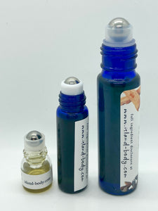 blue glass roller ball bottles, without their cap, showing their stainless steel roller balls